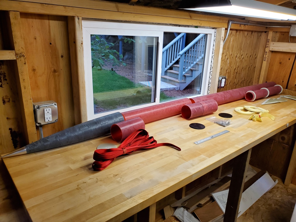 fiberglass rocket parts spread across wooden workbench